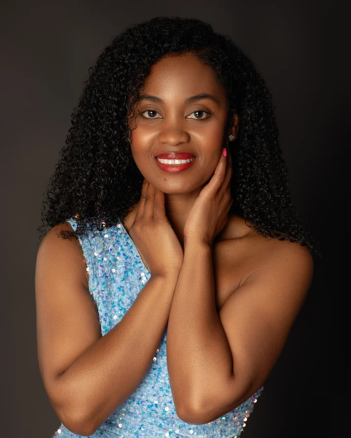 Beauty portrait of a smiling woman with curly hair in a blue sequin top