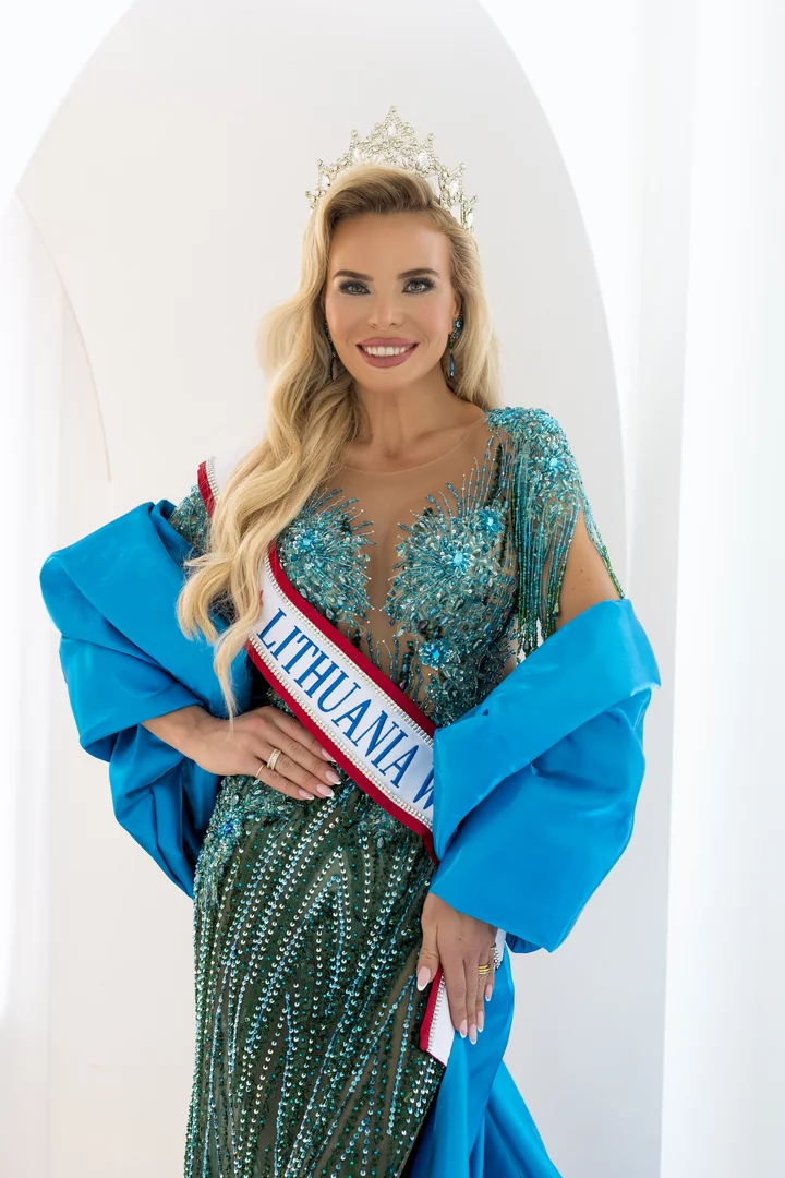 Pageant portrait of a crowned queen in a teal beaded gown and sash